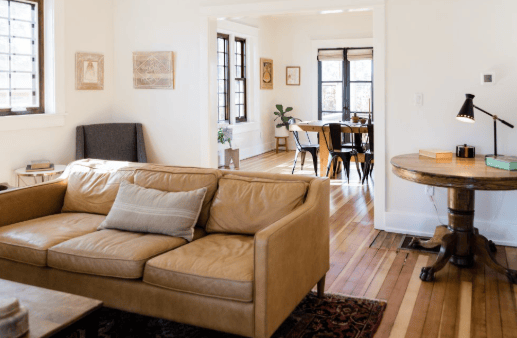 Tidy living room with a leather sofa ready for guests, Airbnb cleaning in Denver Metro