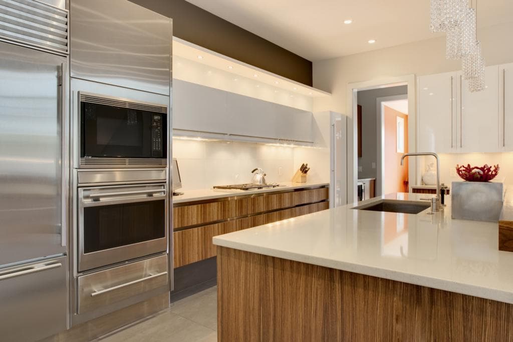 Clean kitchen with polished counters, oven, and microwave, recurring house cleaning in Denver Metro